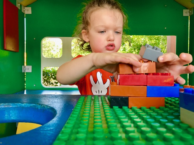 A boy playing lego in duplo valley