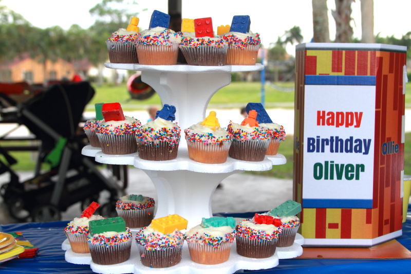 cupcakes on display with a sign that says Happy Birthday Oliver