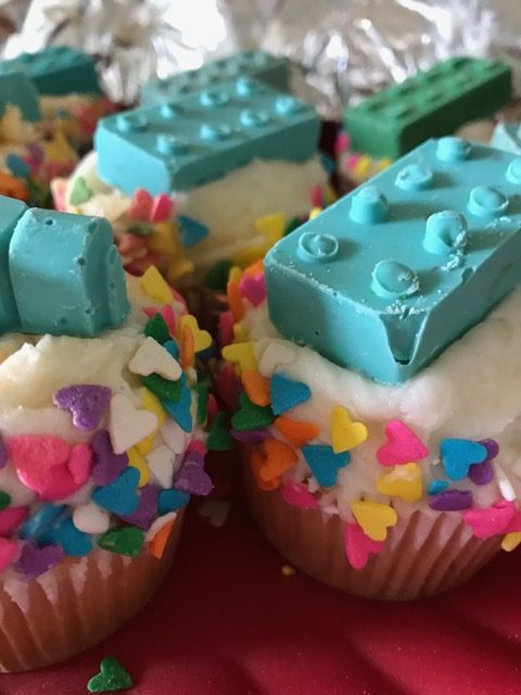 cupcakes with heart sprinkles and chocolate legos on top