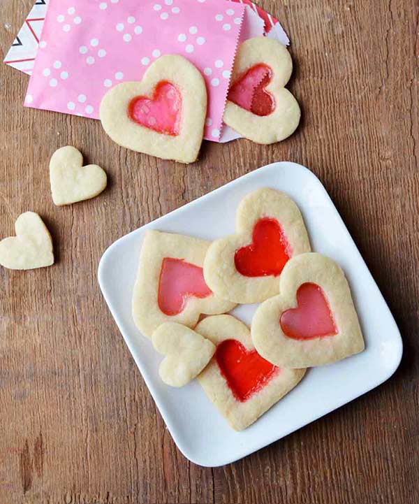 plate of stained glass heart shaped cookies with heart shaped jam
