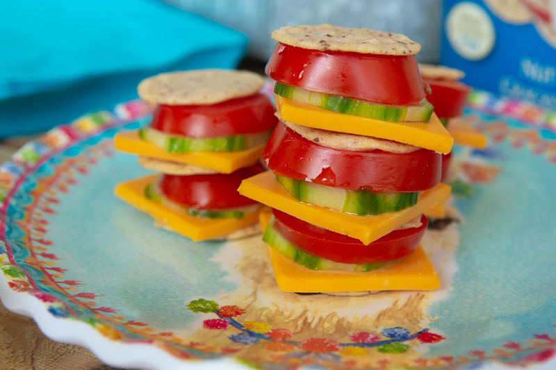 Nut Thins Almond with little tomato, cucumber and cheese cracker sandwhiches. 