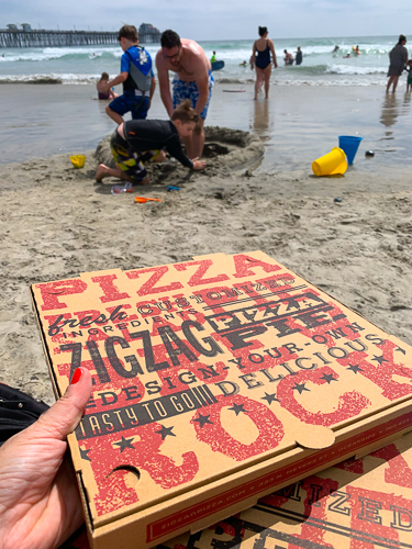 enjoy your delicious pizza with artichokes from zig zag pizza pie at California beach