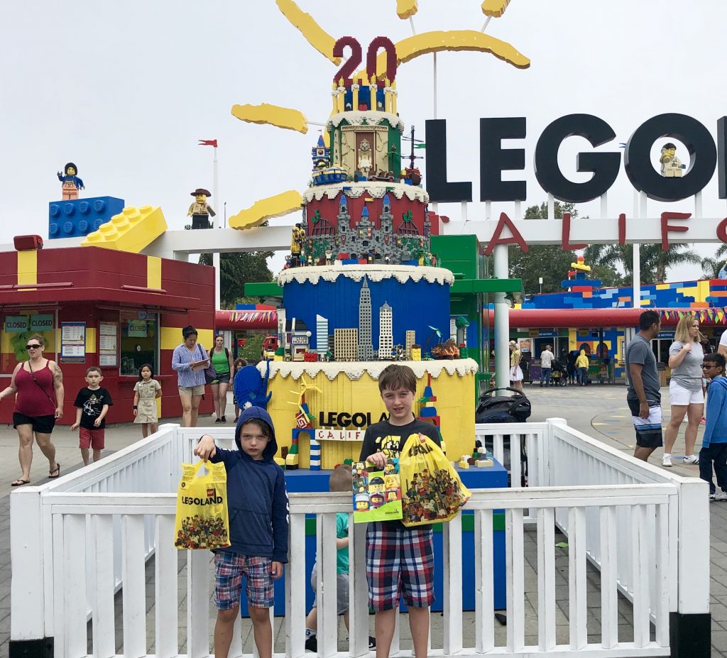 two boys showing their purchases at Legoland California