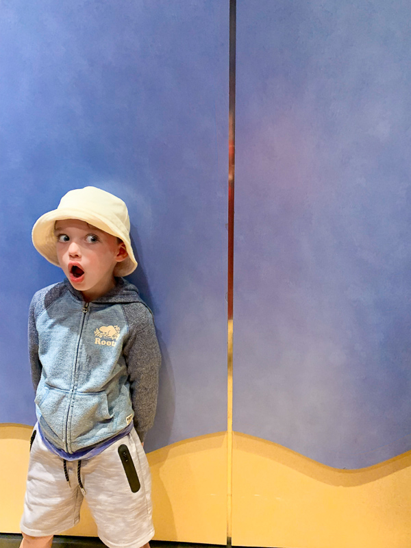 a boy inside an elevator with a surprised face