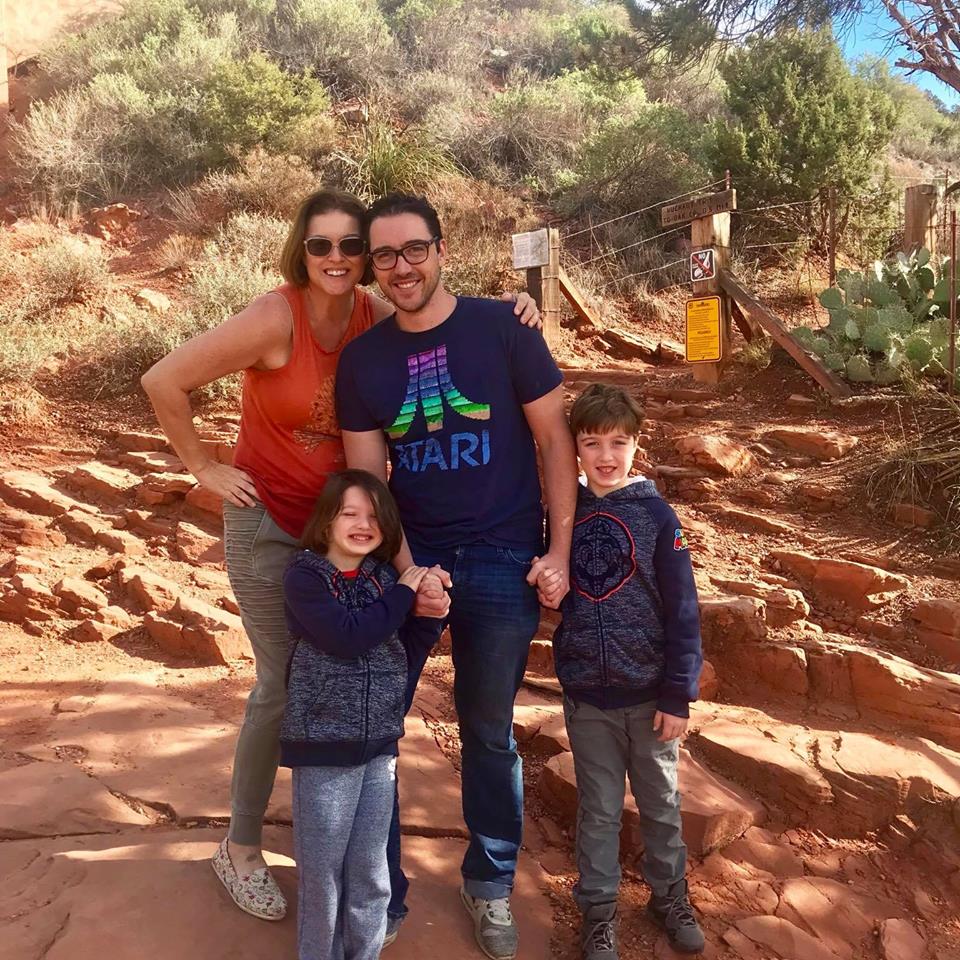 family smiling on a hiking trail
