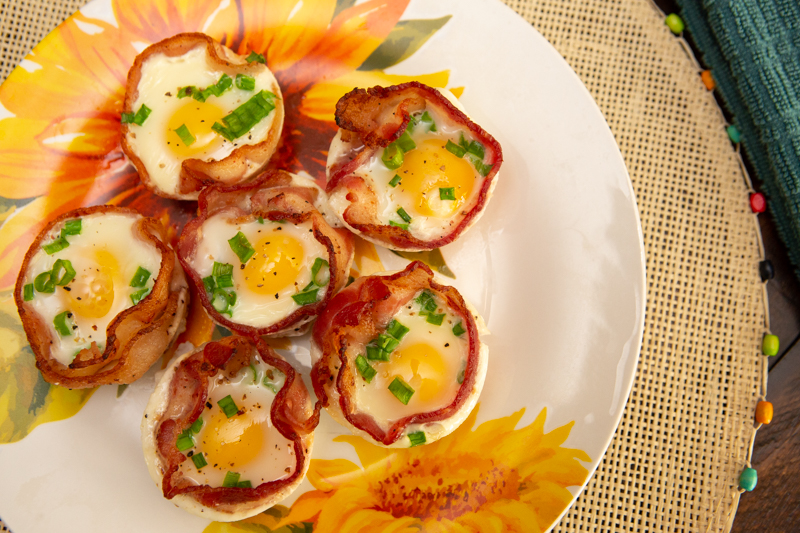 Bacon and egg cups on a sunflower plate