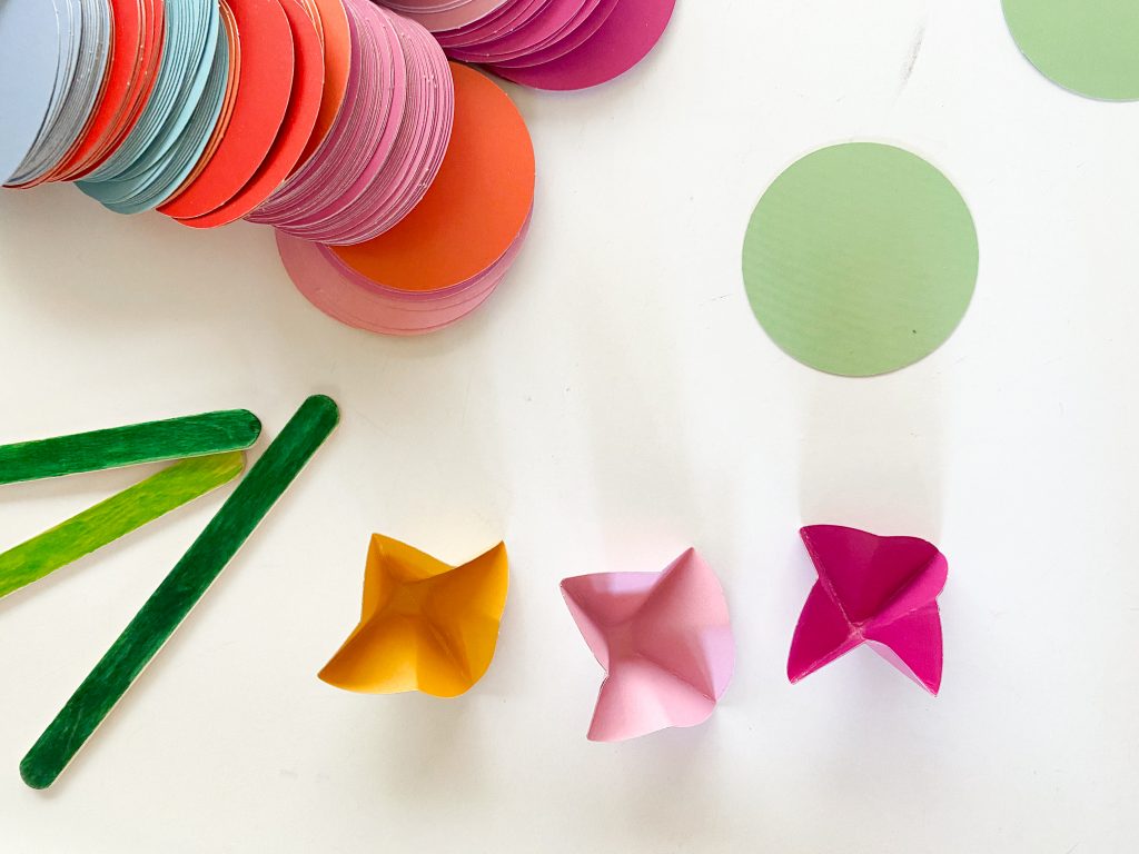 circle paint chips with green wooden sticks and paper flowers