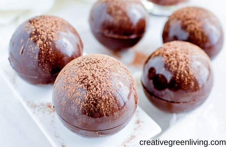 hot chocolate bombs with dusted cocoa on top