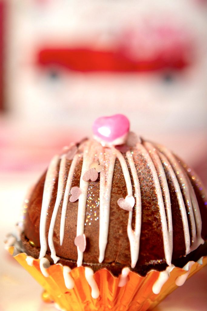 pink hot cocoa bomb with pink edible hearts and icing for marriage proposal idea