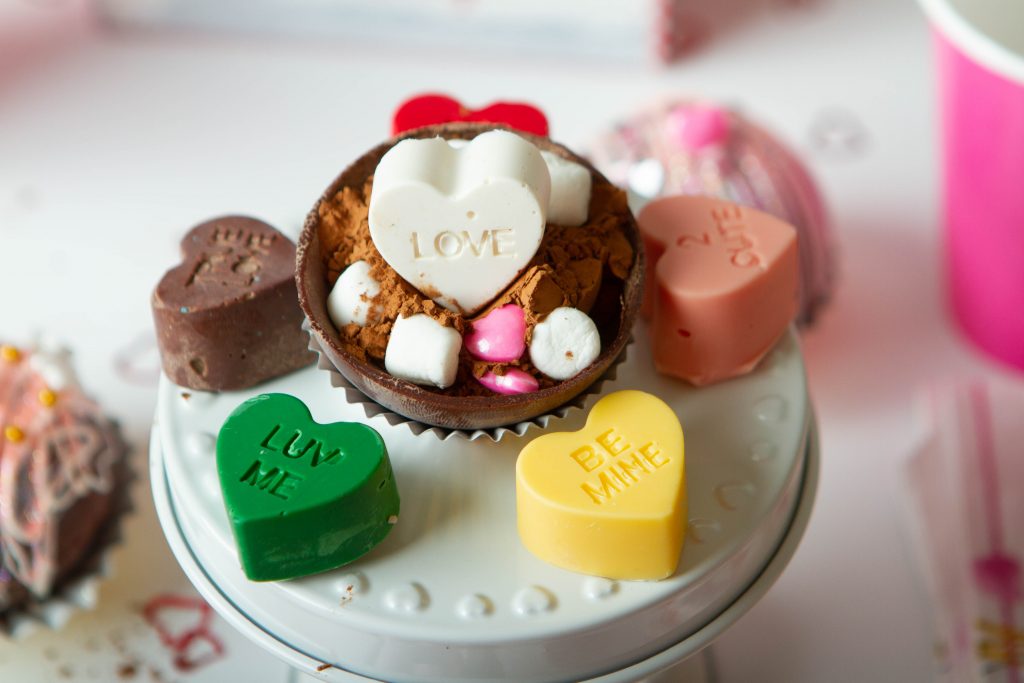 white, yellow and green, pink and chocolate conversation hearts for Valentine's Hot Chocolate Bombs with Conversation Hearts