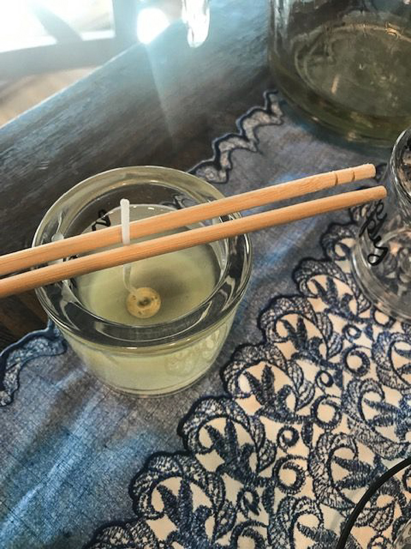 chopsticks holding wick