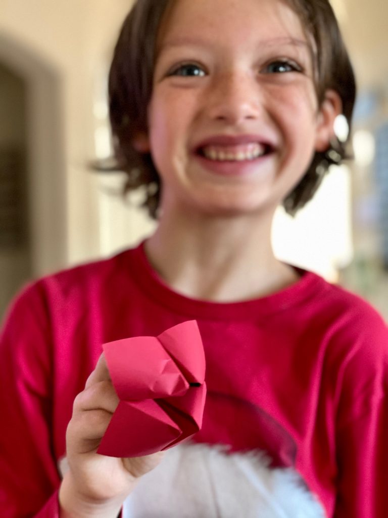 boy holding fortune teller for kid's virtual Birthday party