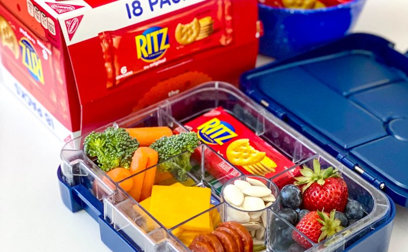 lunch box with ritz crackers in a snack pack and cheese and veggies